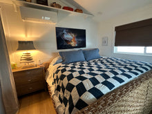 Load image into Gallery viewer, Metal art hangs above a bed.